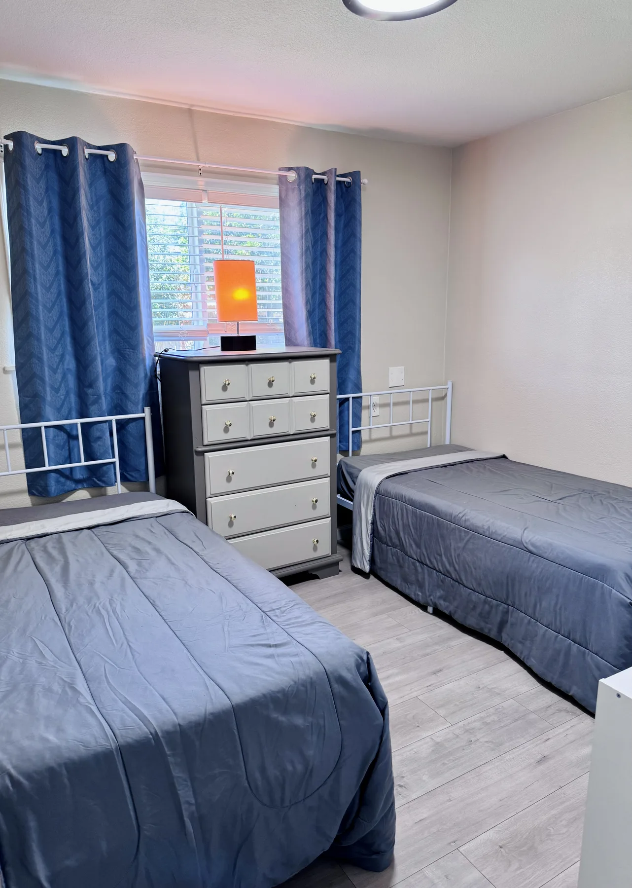 Furnished shared bedroom with two beds